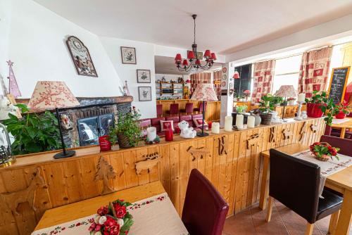 a dining room with a table and a fireplace at Hotel Restaurant La Source in La Foux