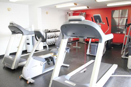 a gym with a treadmill and tread machines at Wyndham Chicago O'Hare in Rosemont