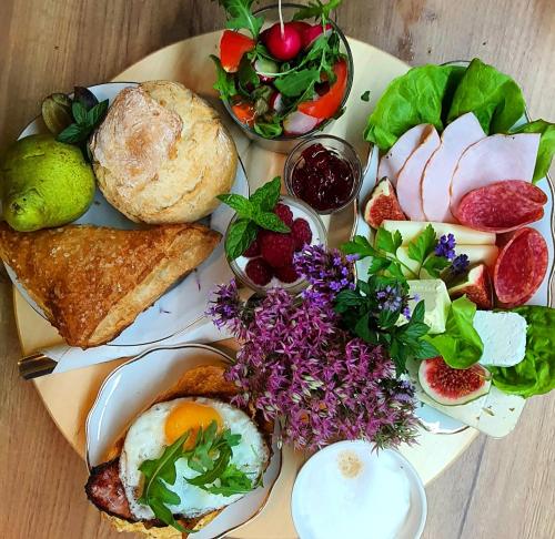 um prato de alimentos com ovos, pão e legumes em Babie Lato b&b em Uniejow