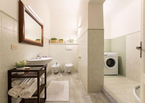 a bathroom with a sink and a washing machine at Terme Apartment in Florence