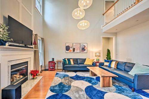 a living room with a blue couch and a fireplace at Tranquil Greensboro Home with Fire Pit! in Greensboro