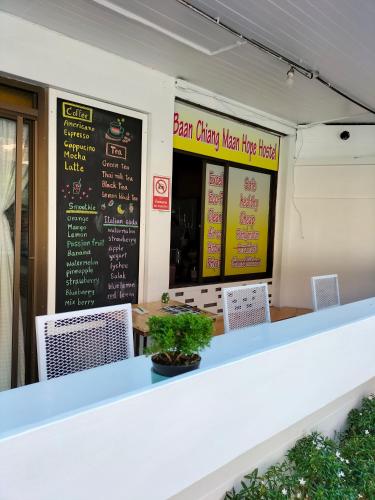 a restaurant with a white counter and signs on the wall at Baan Chiang Maan in Chiang Mai