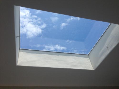 a window in a room with a blue sky at Mu Ju B&B in Magong