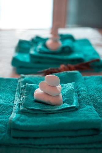 a pile of blue towels with a toy on top at Seafarer's Appartment in Mikonos