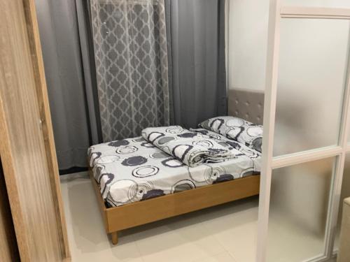 a small bed in a small room with a mirror at Primavera City Brand New Condo Uptown Cagayan de Oro with pool and gym One minute walk from Mall in Cagayan de Oro