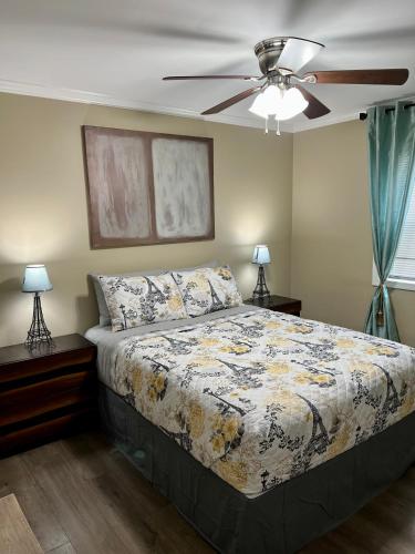 a bedroom with a bed and a ceiling fan at Trinity One Apartments - Country Luxury in Jackson