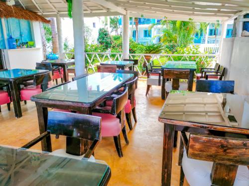 a group of tables and chairs in a restaurant at B&B Aparthotel La Isleta in Las Galeras