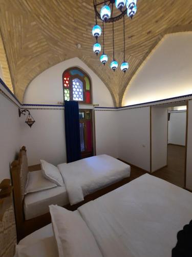 Letto o letti in una camera di Marhaba boutique Madrasah 15th-16th century