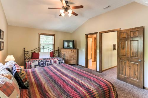 a bedroom with a bed and a ceiling fan at Branson Home with Game Room, Near Silver Dollar City in Branson
