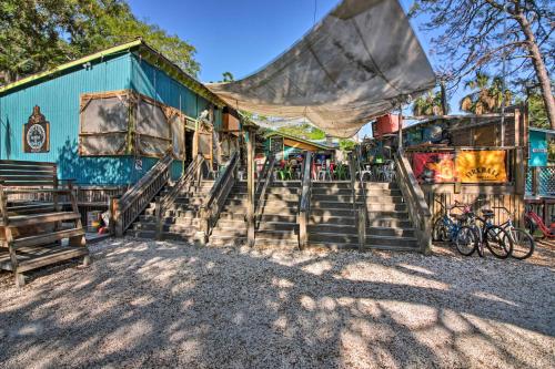 a building with stairs and a largearp over it at Breezy Tybee Island Condo - 100 Yards from Beach! in Tybee Island
