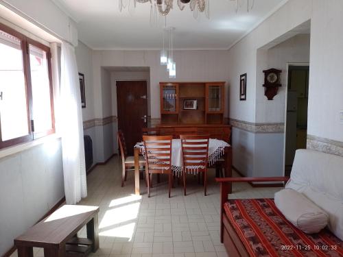 a kitchen and dining room with a table and chairs at Departamento frente al Mar. in Mar del Plata
