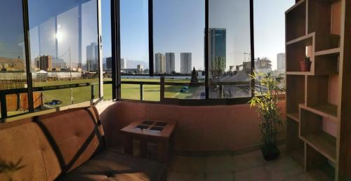 a room with a large window with a view of the city at Dpto frente a Cavancha 6P in Iquique