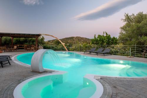 a large swimming pool with a water slide at Affittacamere S'Alzola in Porto Rotondo