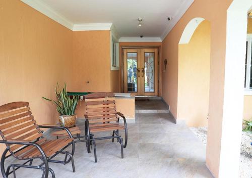 a patio with two chairs and a table with a pool table at Coconut Palms Hideaway in Nassau