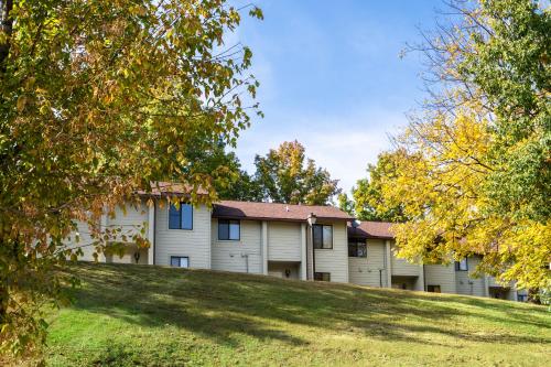 a large white house on a hill with trees at The Villas at French Lick Springs in French Lick