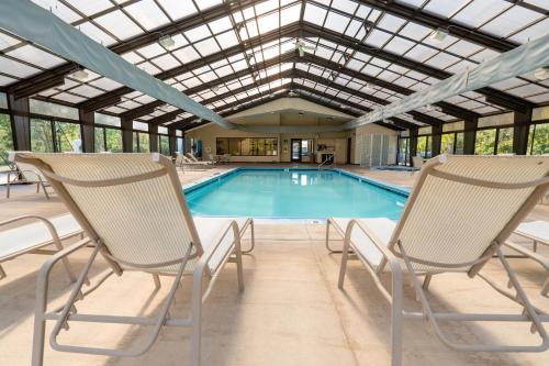 two chairs sitting in front of a swimming pool at The Villas at French Lick Springs in French Lick
