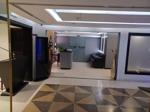 a living room with a couch and a tv in a room at Al Qurum Resort in Muscat