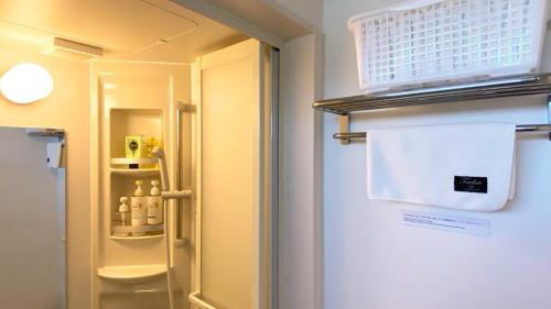 een koelkast met de deur open in een kamer bij MARBLE B&B in Kashima