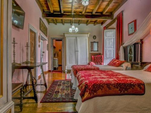 a bedroom with two beds and a couch in it at Casona Dos Lagos in Villanueva