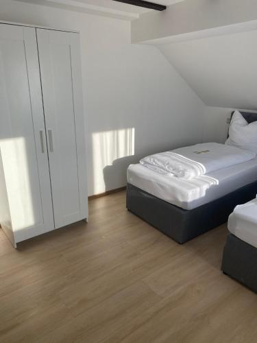 a bedroom with a bed and a white cabinet at Ferienwohnung Siegen Eiserfeld 2 in Siegen