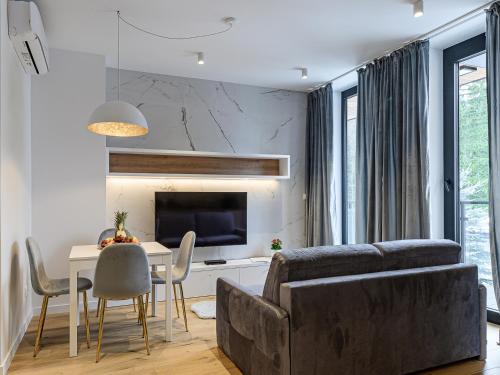 uma sala de estar com um sofá e uma mesa em VisitZakopane- Toscana Apartment em Zakopane