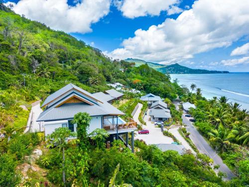 an aerial view of a resort on a hill next to the ocean at Paradise Chalets Yoga & Wellness in Takamaka
