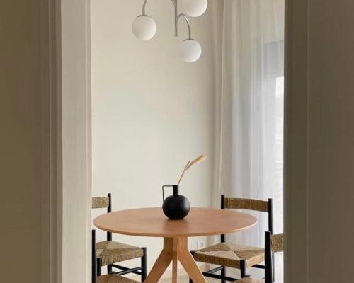 a dining room table with chairs and a vase on it at The Appartment in Llança