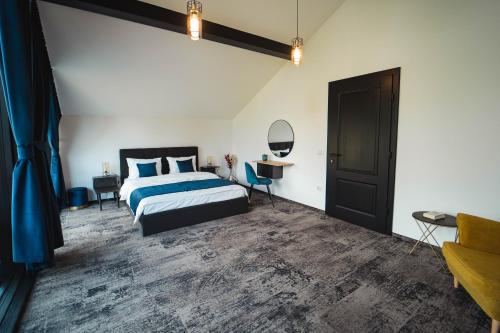 a bedroom with a bed and a table and a mirror at Georgia Chalet in Dorna Arini