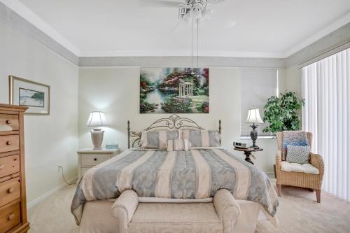 a bedroom with a large bed and a chandelier at Fort Myers Fantasy in Fort Myers