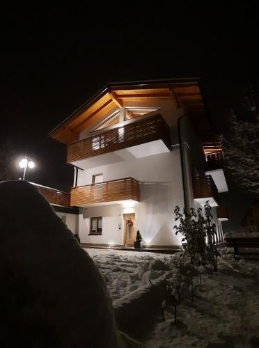 a house at night with the lights on at Il giardino di Anna - Appartamento 1 in Fai della Paganella
