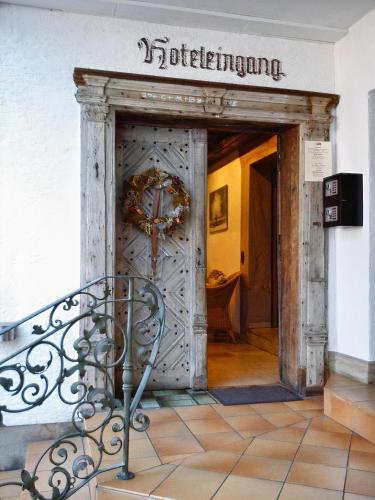 an entrance to a building with a wooden door at Hotel Burg Breuberg in Höchst im Odenwald