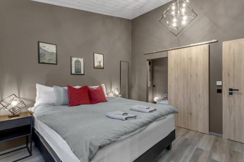 a bedroom with a large bed with two towels on it at The Lava Bowl in Grindavík