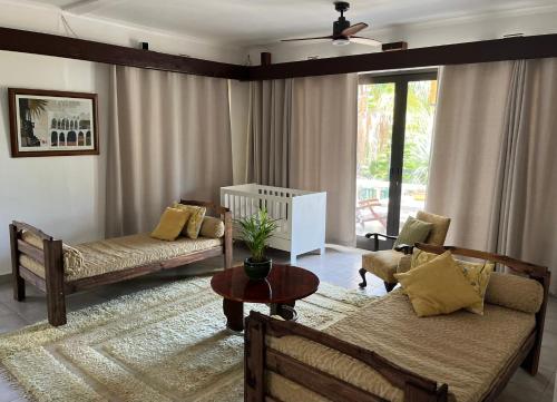 a living room with two couches and a table at Santika Villa Stellenbosch in Stellenbosch