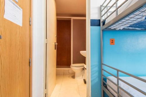 a small room with a bunk bed and a toilet at Sea Hostel Barcelona in Barcelona