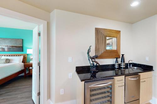 a kitchen with a sink and a bathroom with a bed at Caribe D216 in Orange Beach
