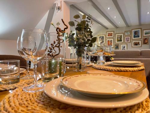 a table with plates and wine glasses on it at Au café de Jeanne - Entrelacs in Pouilly