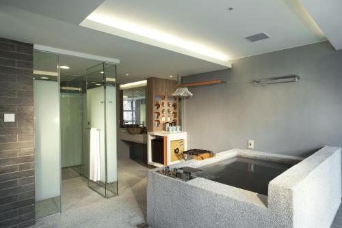 a bathroom with a bath tub in a room at Just Sleep Jiao Xi in Jiaoxi