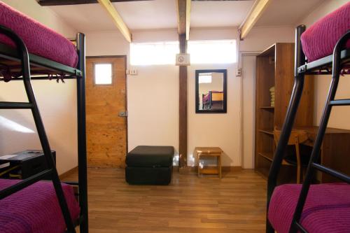 a room with two bunk beds and a hallway at Hotel-Camping Takha Takha in San Pedro de Atacama