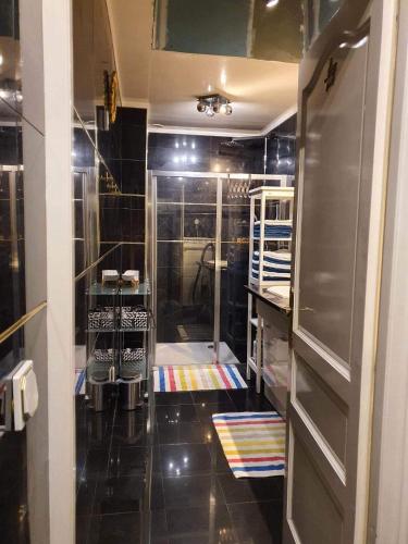 a bathroom with a shower with a glass door at Villa Baroque in Pierrefitte-sur-Seine