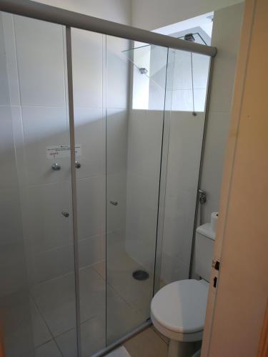 a bathroom with a shower and a toilet at Hotel Guarda Mor in São Sebastião