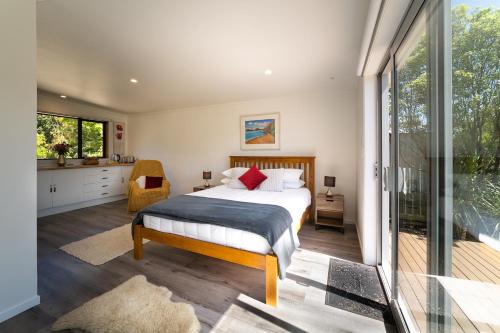 a bedroom with a bed and a balcony at River View Collingwood in Collingwood