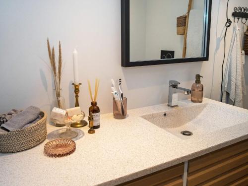 a bathroom counter with a sink and a mirror at Holiday home Thisted LIII in Thisted