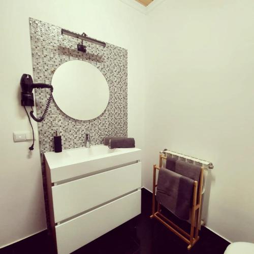 a bathroom with a sink and a mirror at Sotam Country House EN342 in Góis