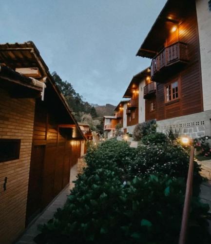 a courtyard of a building with plants and lights at Pousada Aracê in Pedra Azul