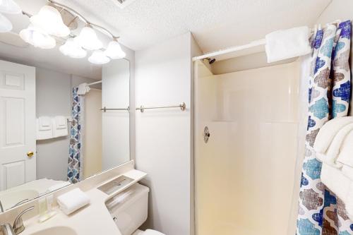 a bathroom with a sink and a toilet and a mirror at Winterplace G101 in Ludlow