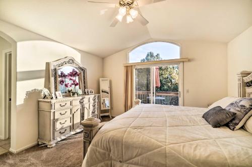 a bedroom with a bed and a mirror and a window at Littleton Home with Patio - 8 Mi to Red Rocks in Littleton