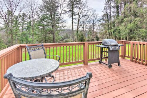a grill on a wooden deck with a table and chairs at Mountain-View Zirconia Home Walk to Lake Summit! in Zirconia