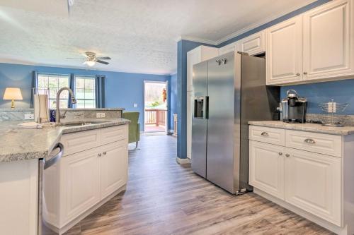 a kitchen with white cabinets and a stainless steel refrigerator at Mountain-View Zirconia Home Walk to Lake Summit! in Zirconia