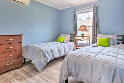 a bedroom with two beds and a dresser and a window at Mountain-View Zirconia Home Walk to Lake Summit! in Zirconia
