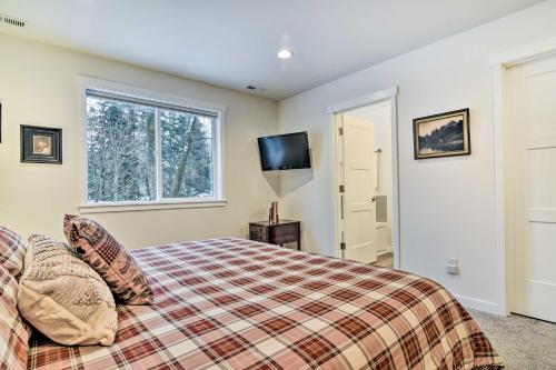 a bedroom with a bed and a tv and a window at Family-Friendly Packwood Retreat with Deck! in Packwood
